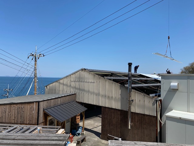 下灘の焼杉工場の屋根を補修している写真